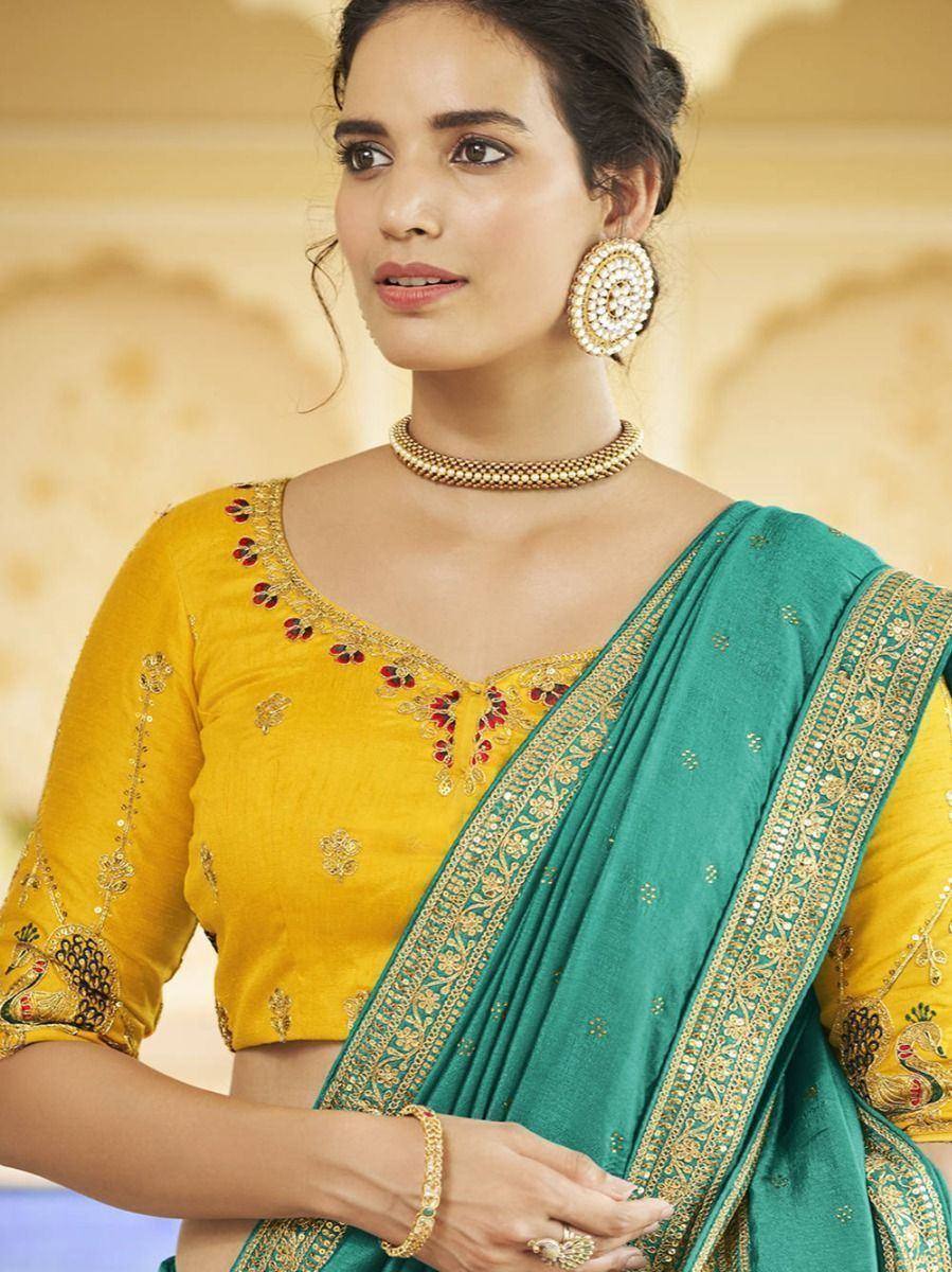Yellow embroidered blouse with green saree, gold jewelry, Indian ethnic wear