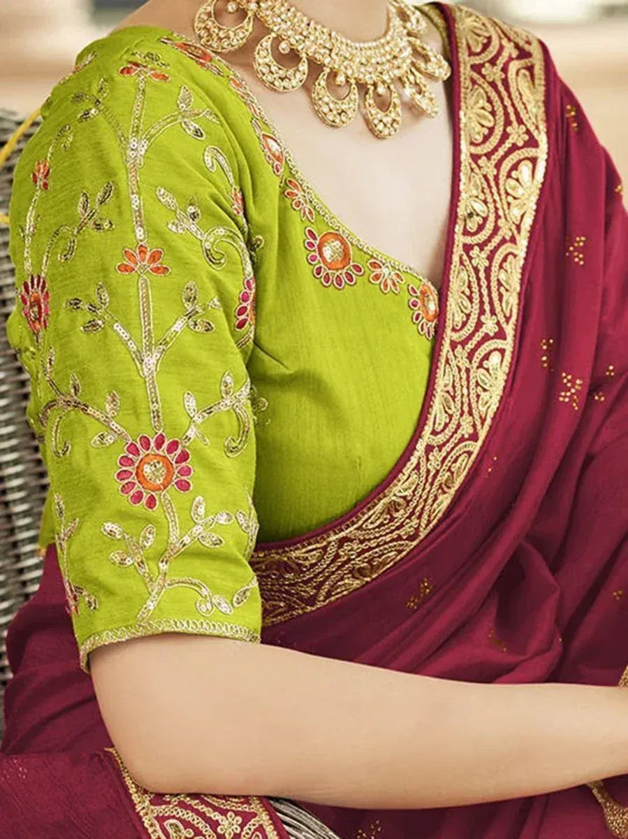 Green embroidered blouse with maroon saree, gold jewelry, floral zari work, Indian ethnic wear