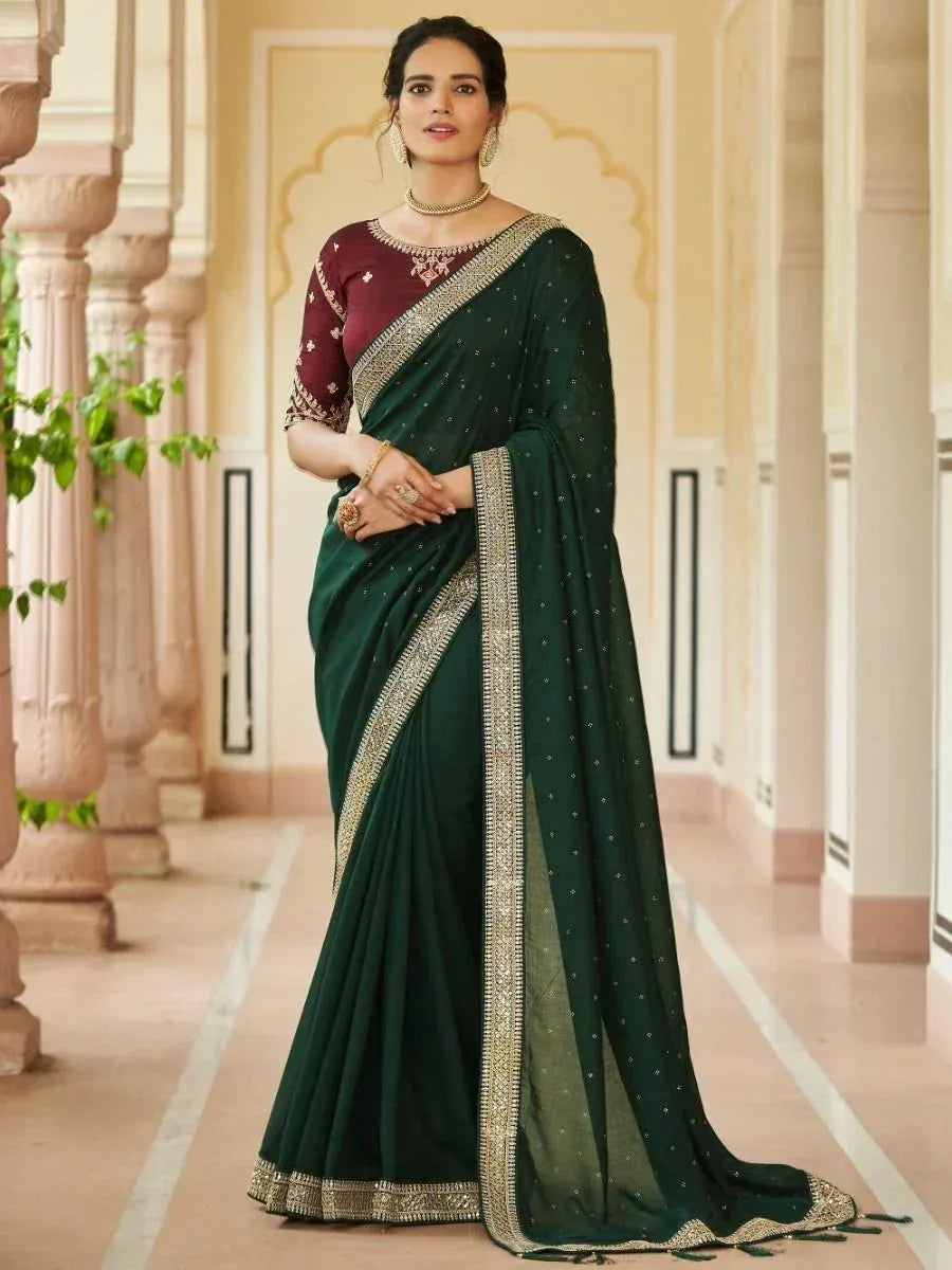 Elegant dark green saree with gold embroidery, paired with maroon blouse, perfect for Indian ethnic occasions