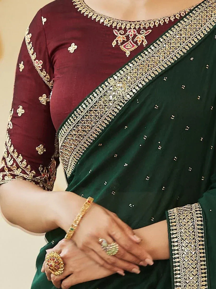 Emerald green saree with gold embroidery paired with maroon blouse, perfect for Indian ethnic occasions.