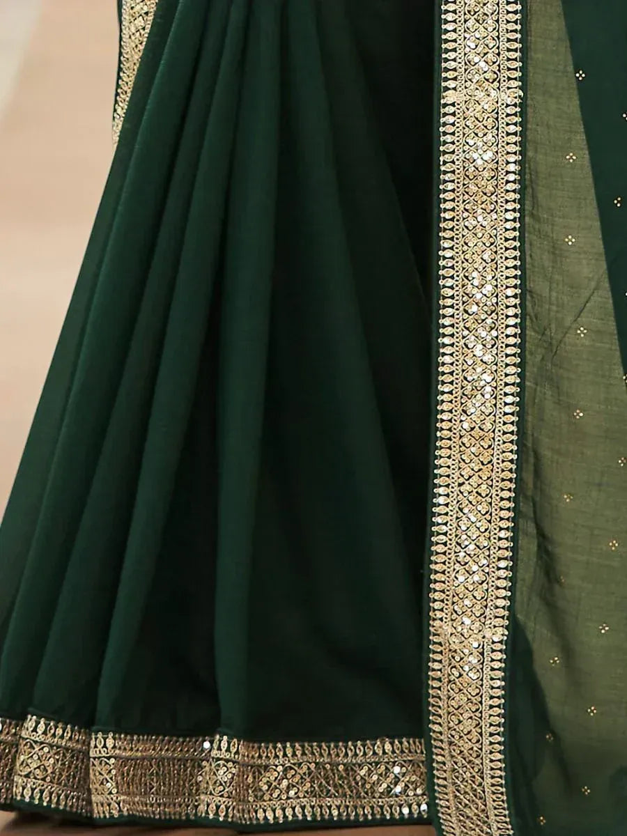 Emerald green lehenga with gold embroidery and sequin border, ethnic Indian wear