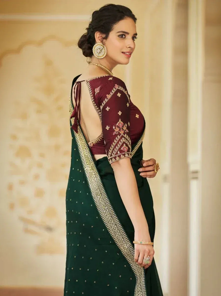 Elegant green saree with gold border and maroon embroidered blouse, perfect for Indian ethnic occasions.