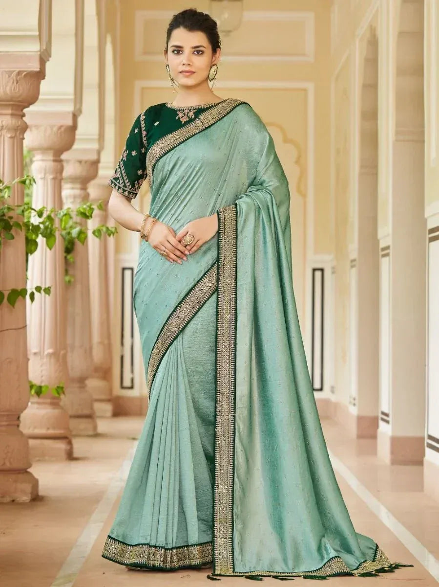 Elegant mint green saree with gold border and embroidered dark green blouse, perfect for Indian ethnic occasions.