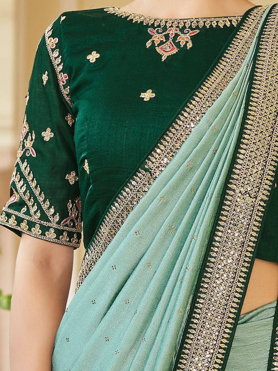 Emerald green embroidered blouse with mint saree, gold zari border, perfect for Indian ethnic wear occasions