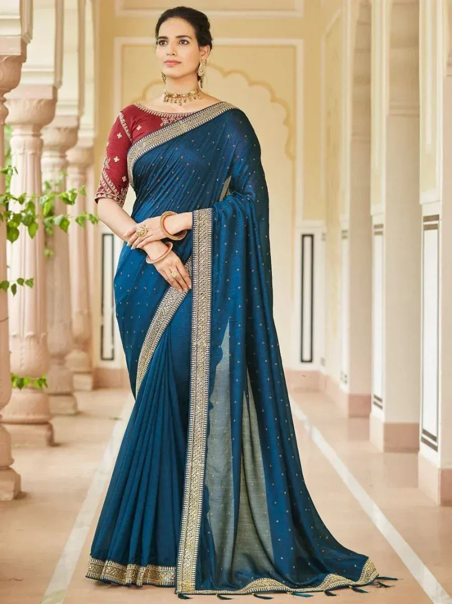 Elegant blue saree with gold border and red blouse, perfect for Indian ethnic occasions