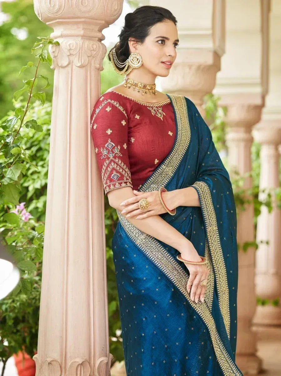 Woman in blue saree with gold border and red embroidered blouse, traditional Indian ethnic wear