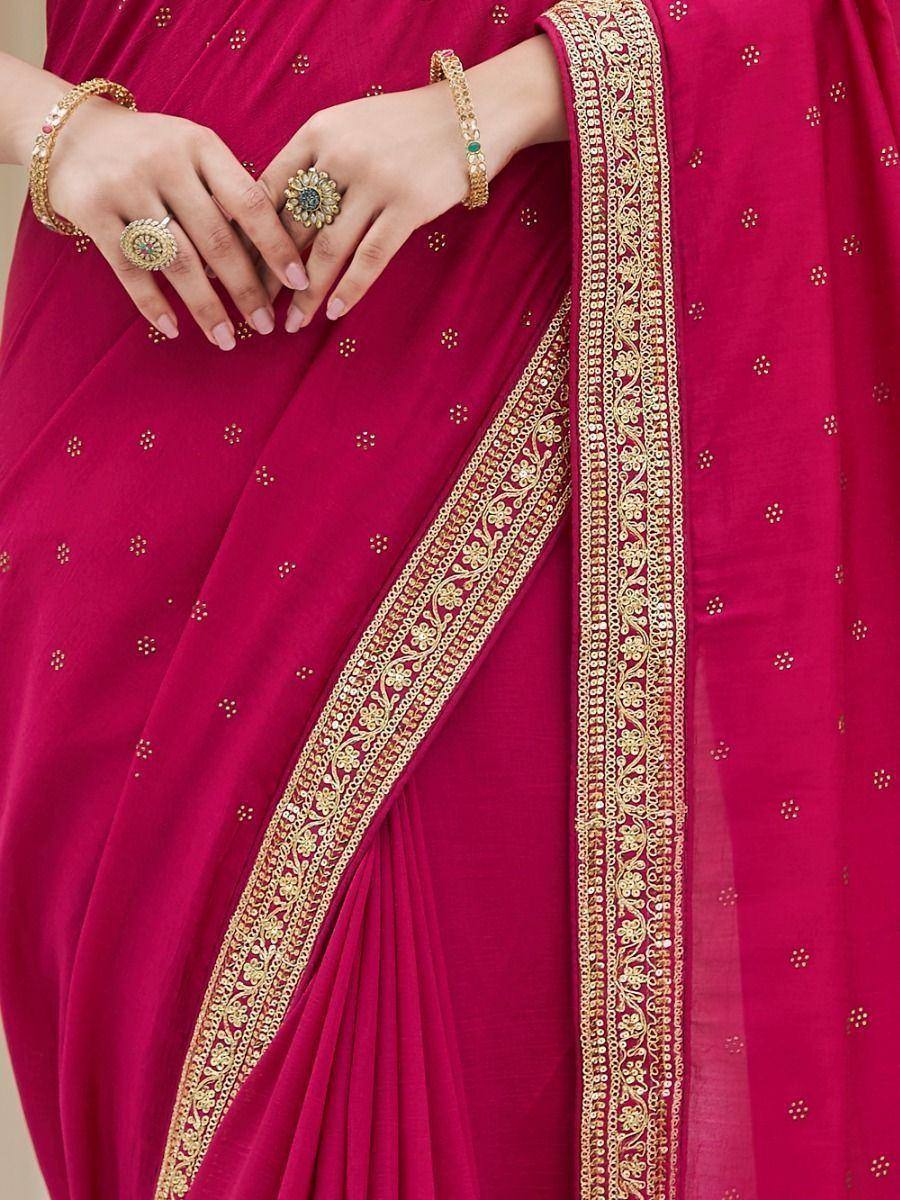 Magenta saree with gold floral embroidery and matching jewelry for ethnic wear