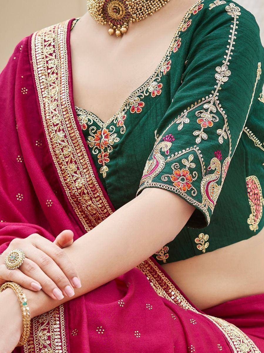 Green embroidered blouse with maroon saree, gold floral detailing, and traditional Indian jewelry