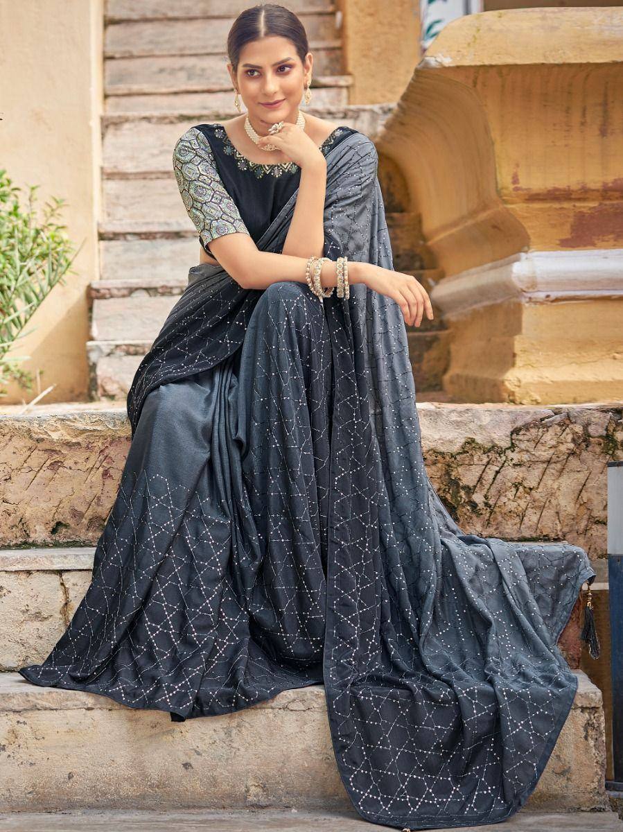 Elegant black saree with geometric embroidery, styled with pearl jewelry, perfect for Indian ethnic occasions.