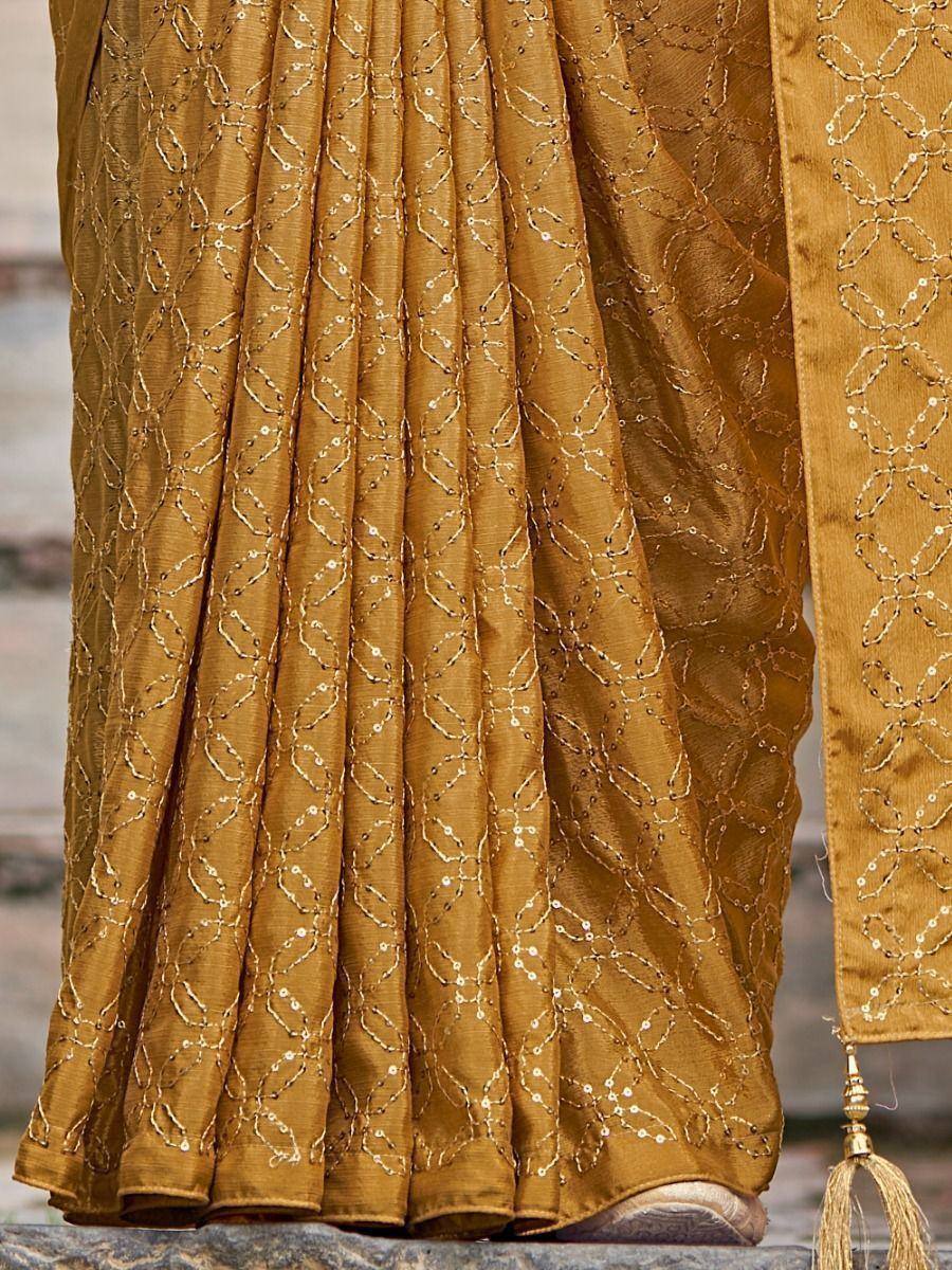 Golden saree with intricate sequin embroidery and tassel detail, perfect for ethnic occasions