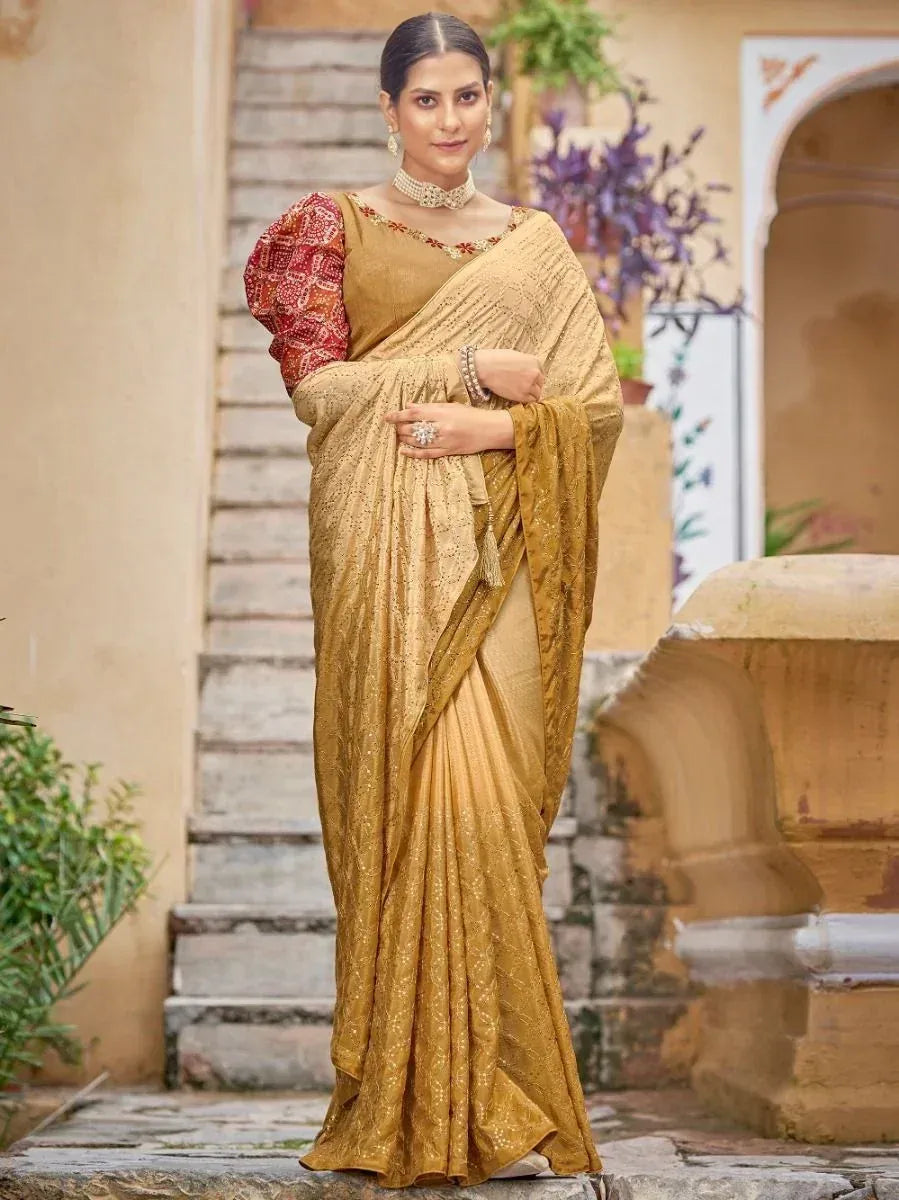 Elegant gold embroidered saree with red patterned blouse, perfect for Indian ethnic occasions