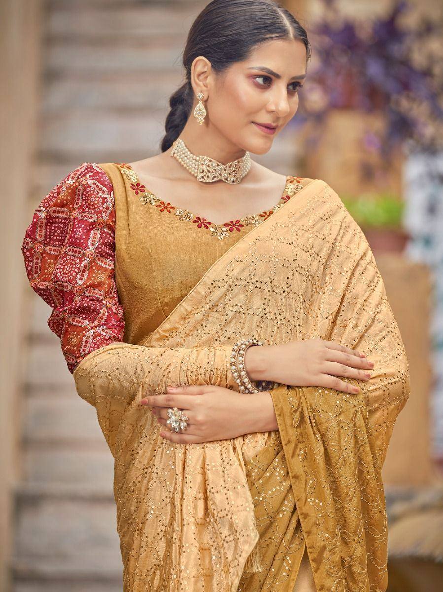 Elegant gold saree with red printed blouse, perfect for Indian ethnic occasions and festive wear.