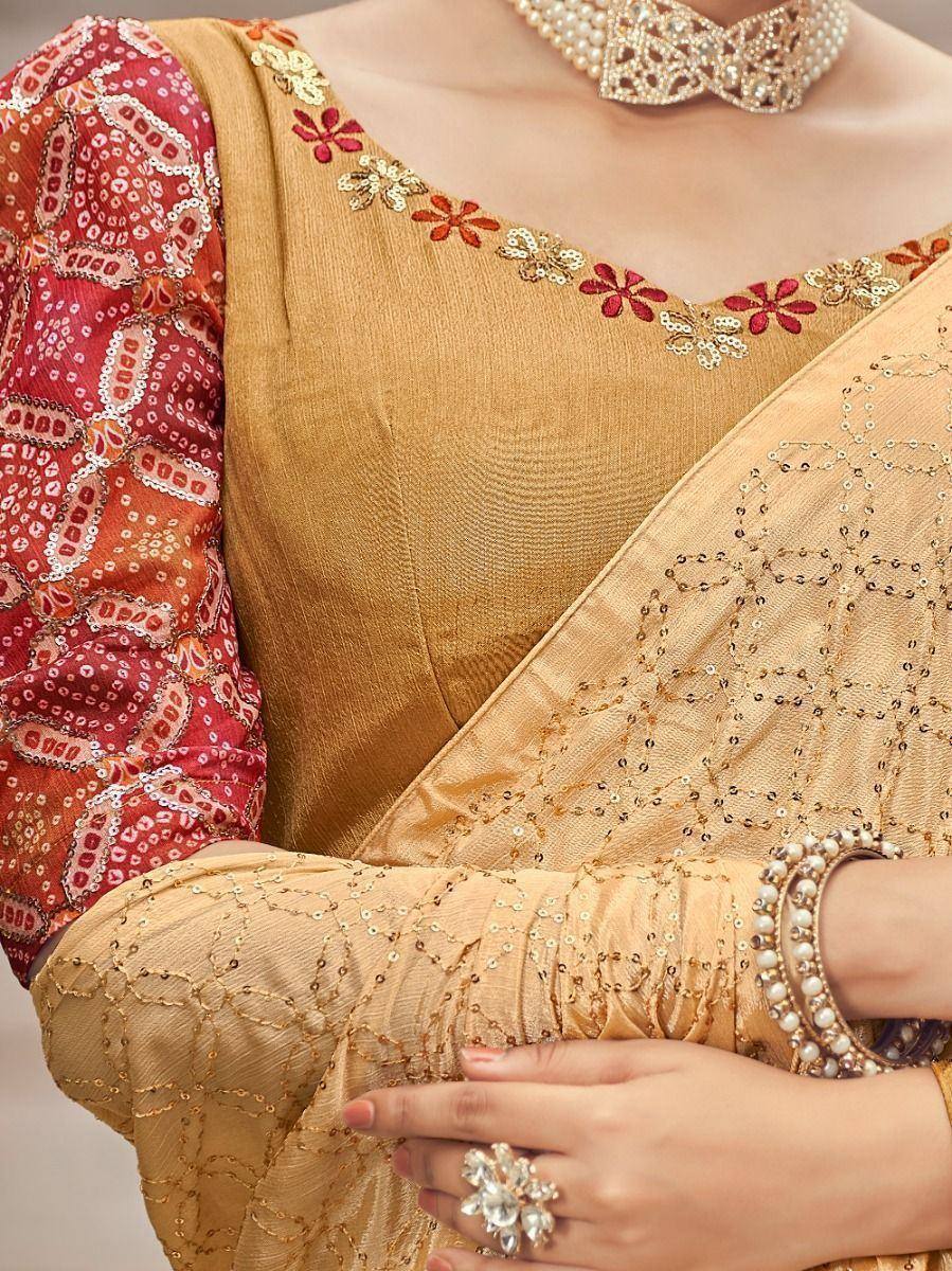 Golden embroidered saree with red floral blouse, pearl jewelry, and sequin detailing for Indian ethnic wear