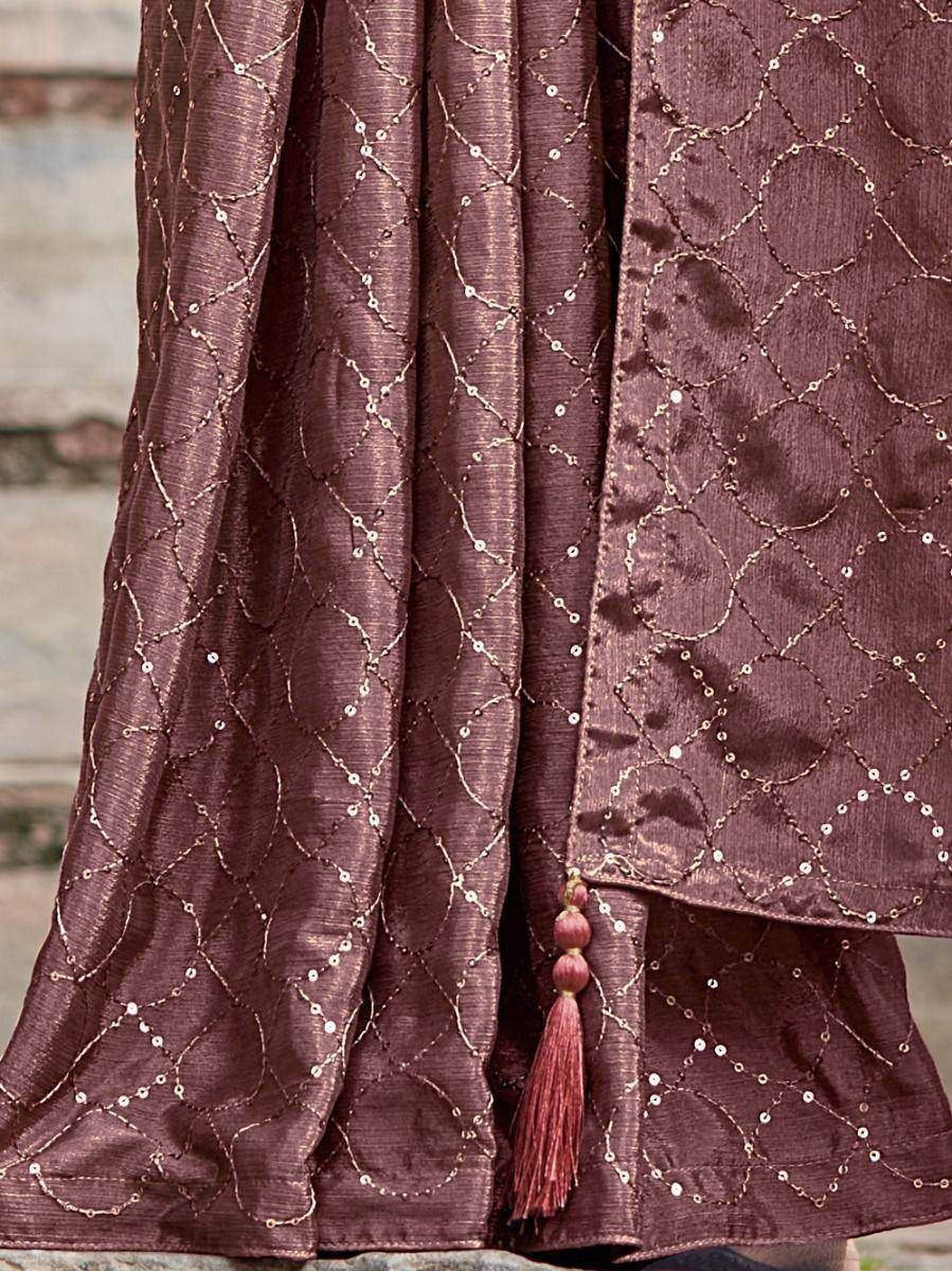 Maroon ethnic gown with gold thread embroidery and sequin detailing, featuring a tassel accent.