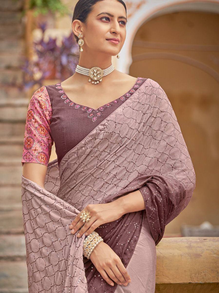 Elegant mauve saree with geometric embroidery, paired with floral blouse and pearl jewelry for Indian ethnic wear