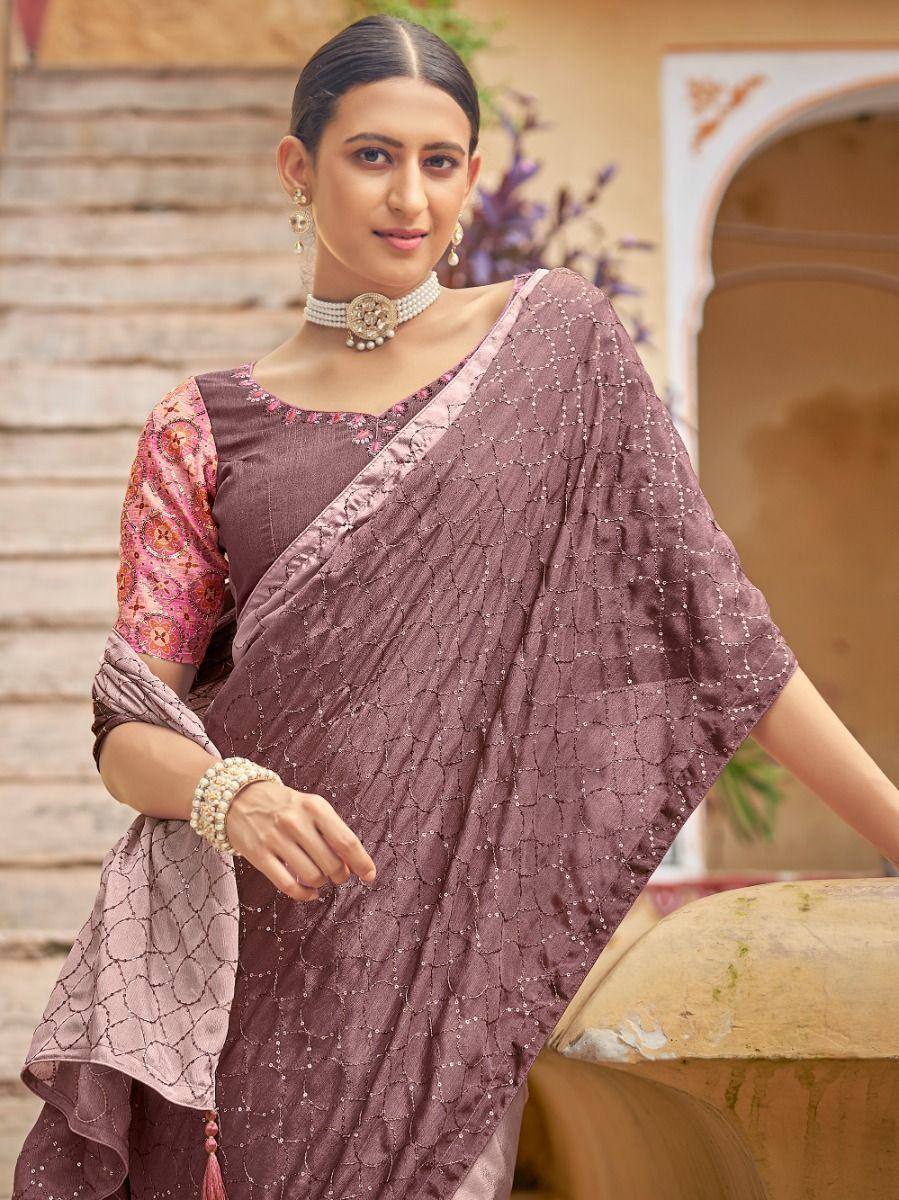 Elegant mauve saree with geometric embroidery, paired with floral blouse, perfect for ethnic occasions