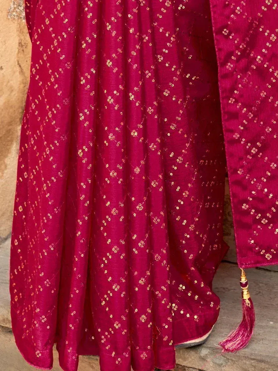 Rich maroon ethnic gown with gold floral embroidery and tassel detail, perfect for festive occasions.