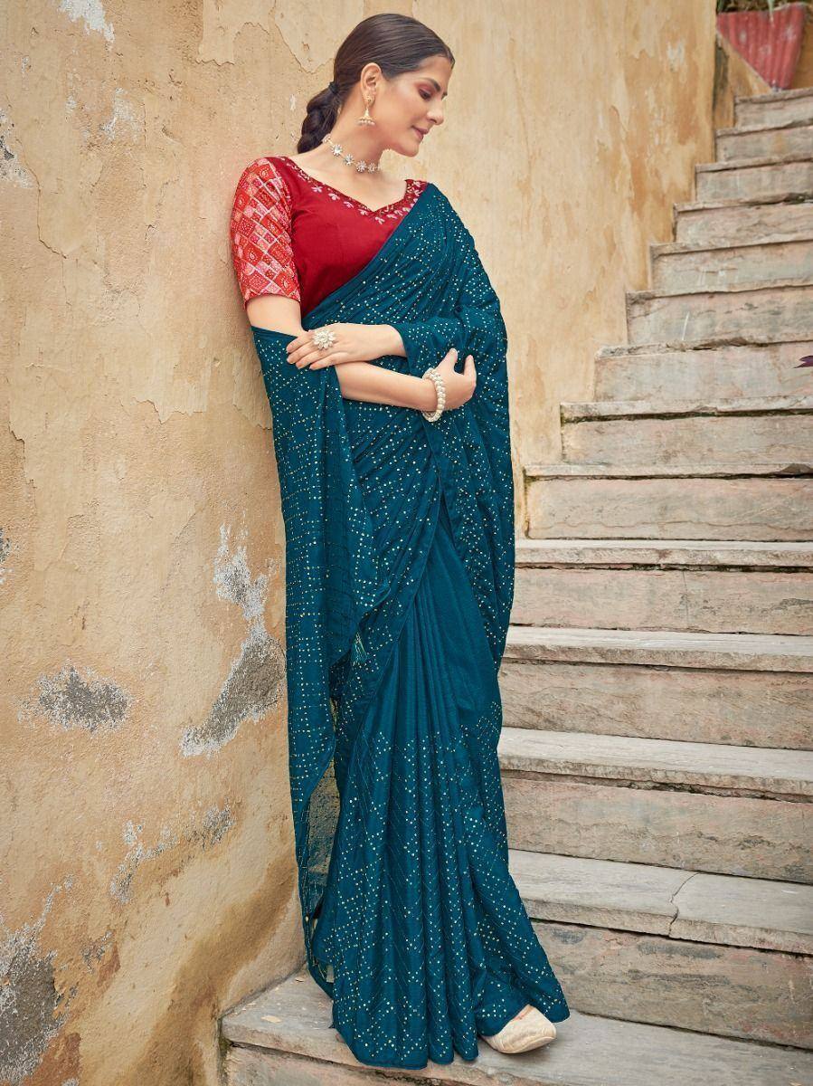Teal embroidered saree with red blouse, styled for Indian ethnic wear occasions
