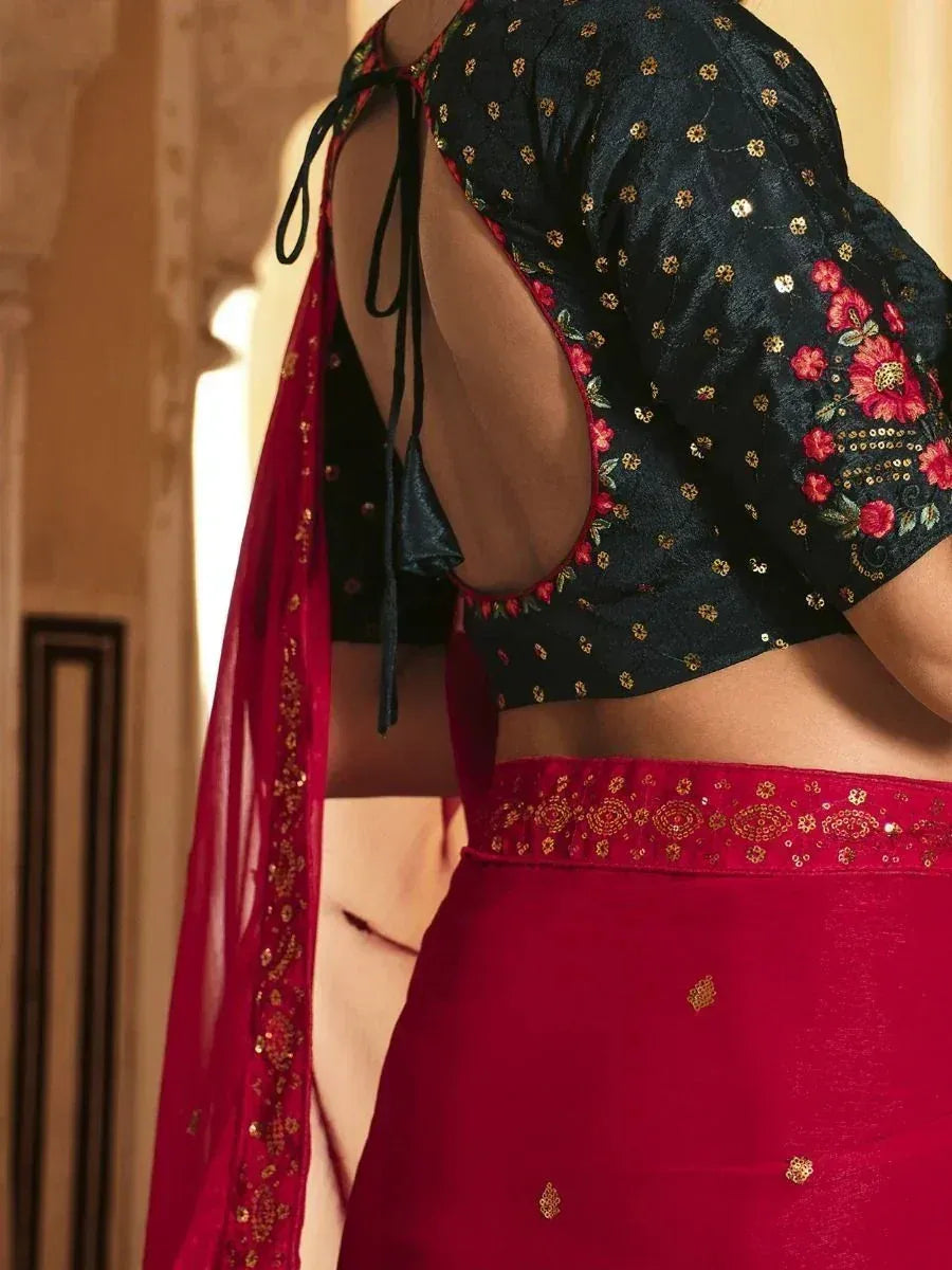 Black floral blouse with red saree, gold embroidery, and back tie detail