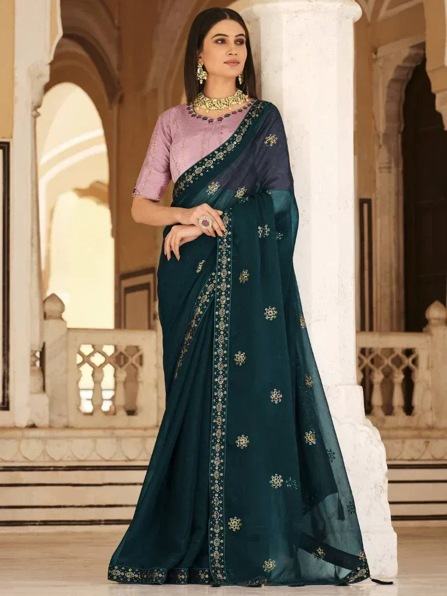 Elegant teal saree with gold embroidery, paired with lavender blouse, perfect for Indian ethnic occasions.