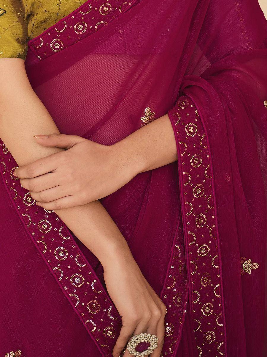 Elegant maroon saree with gold embroidery and sequin border, paired with a yellow blouse for Indian ethnic wear
