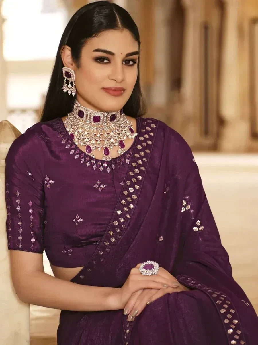 Purple designer saree with intricate embroidery and matching jewelry for Indian ethnic wear