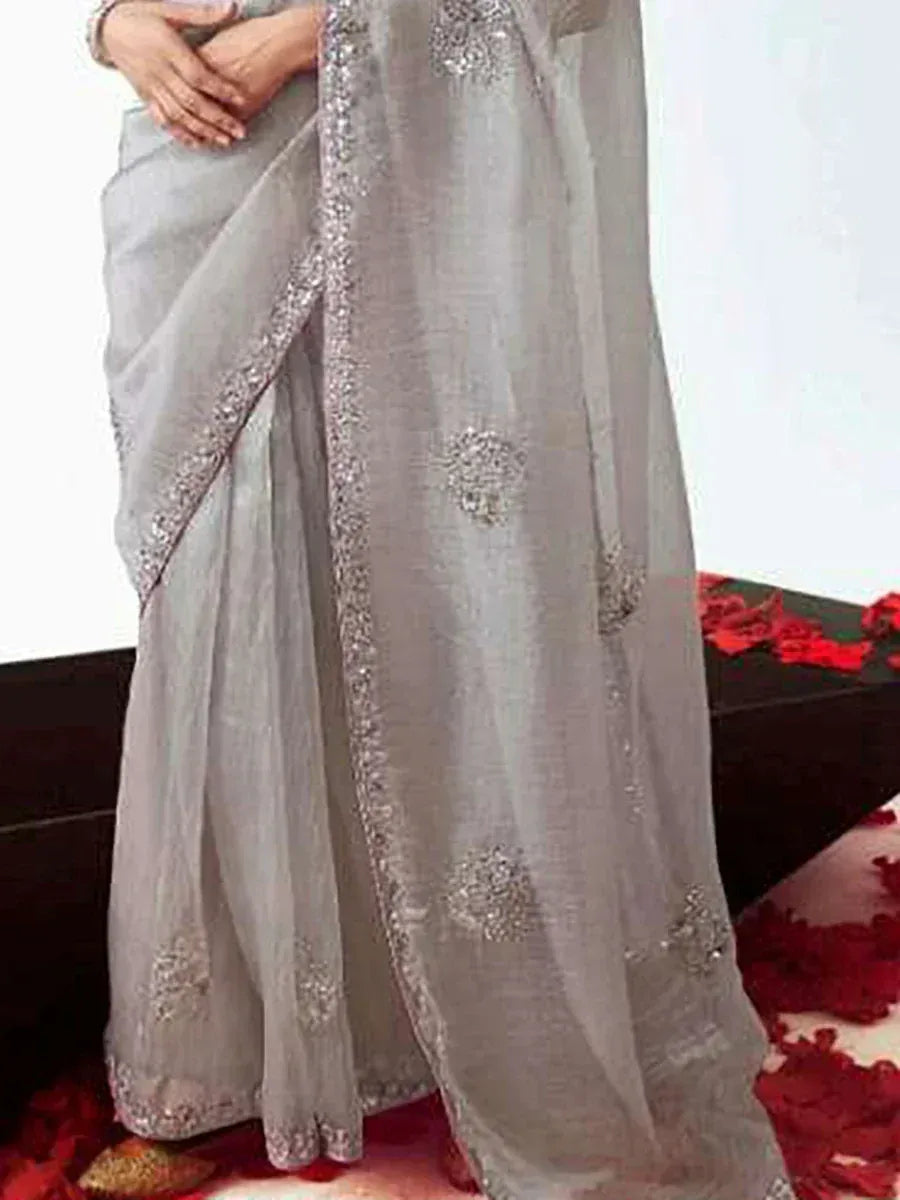 Elegant grey saree with silver embroidery and sequin border, styled with red rose petals