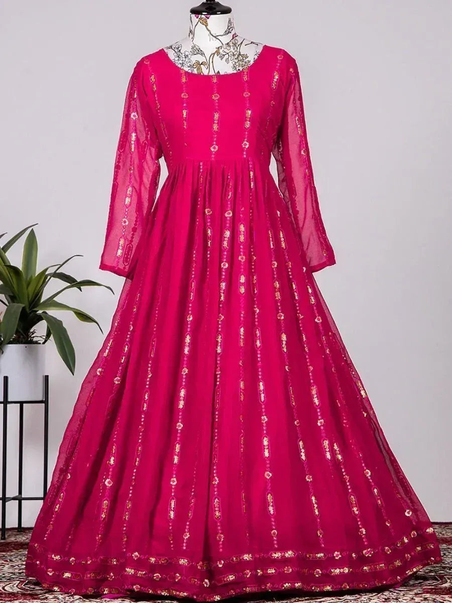 Fuchsia ethnic gown with gold embroidery, long sleeves, and flared skirt for Indian occasions