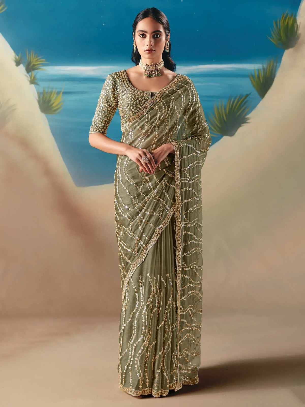 Olive green designer saree with gold embroidery, perfect for Indian ethnic wear occasions.