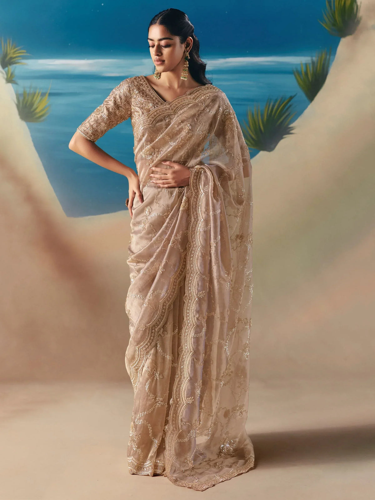 Elegant beige embroidered saree with gold detailing, perfect for Indian ethnic wear occasions.