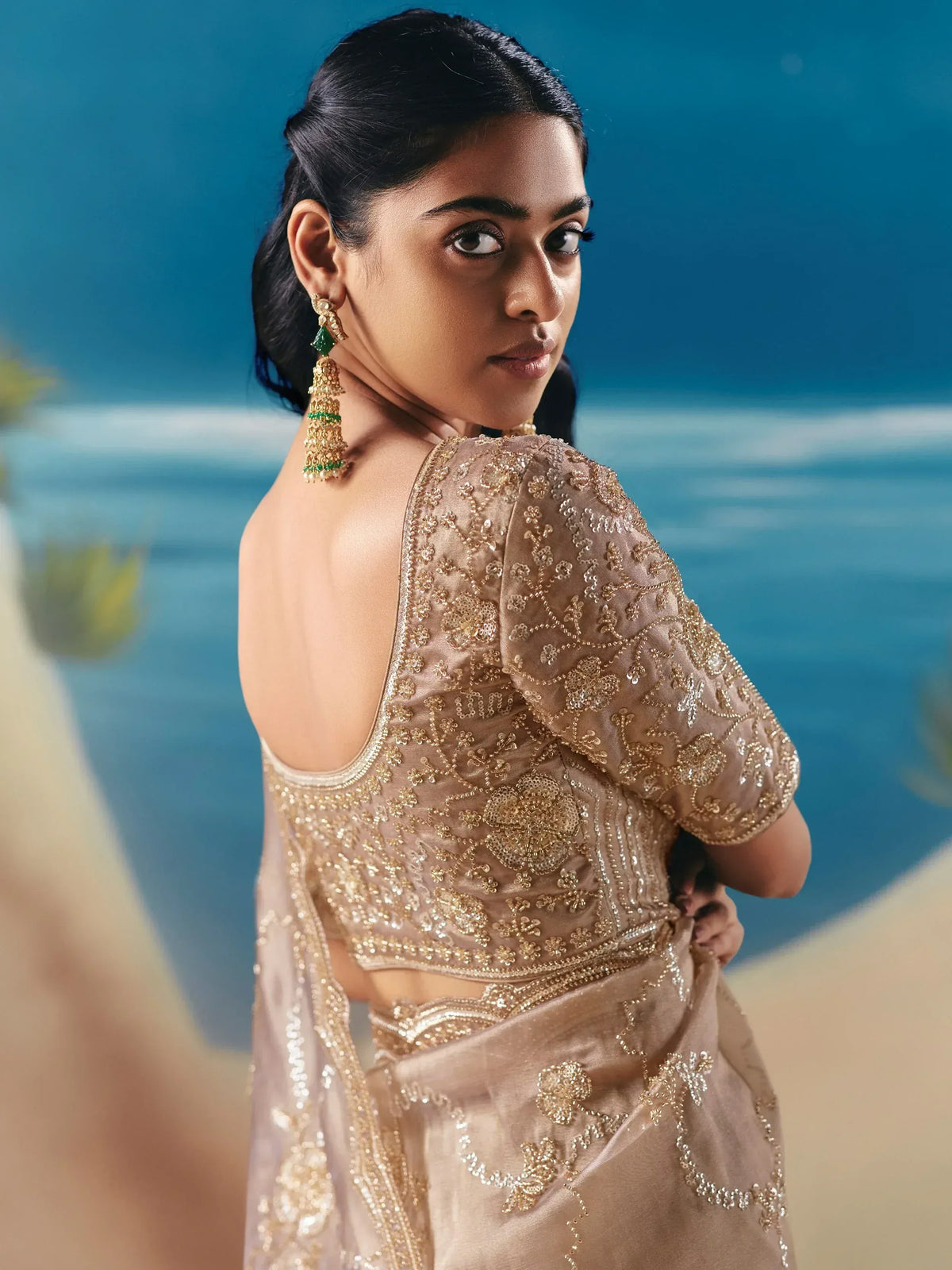 Elegant gold-embroidered saree with backless blouse, perfect for Indian ethnic wear events.