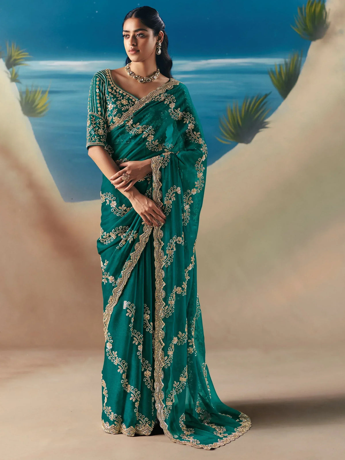 Emerald green designer saree with gold embroidery, perfect for Indian ethnic wear and festive occasions.