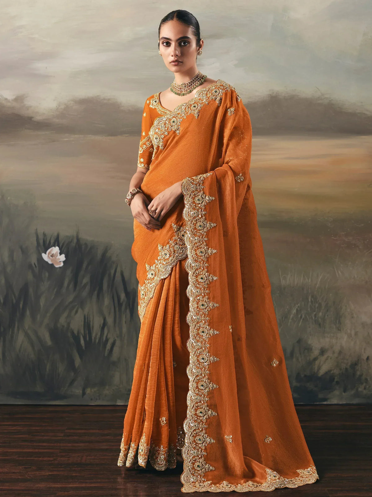 Orange embroidered saree with gold detailing, perfect for Indian ethnic wear occasions