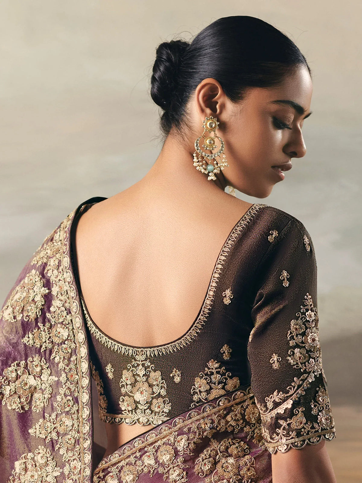 Elegant Indian saree with intricate gold embroidery and backless blouse design