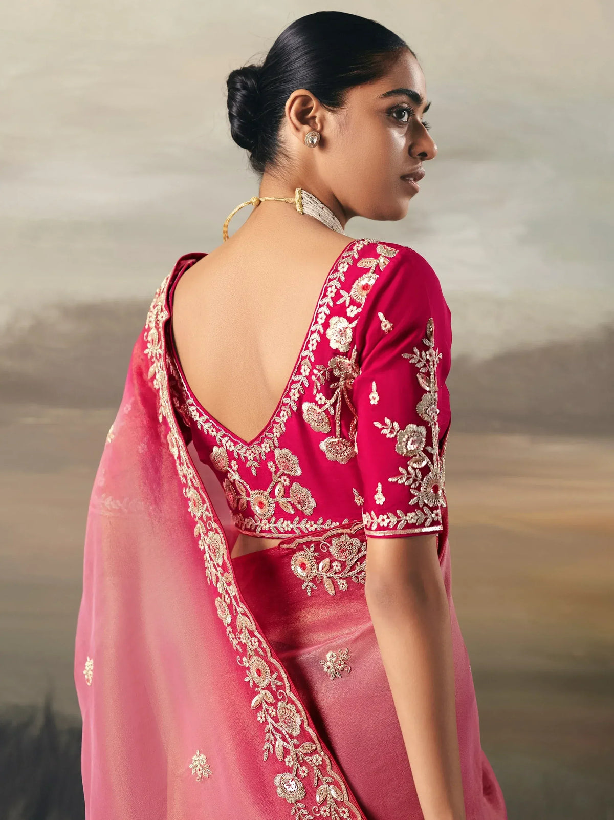 Elegant pink saree with gold floral embroidery and backless blouse design