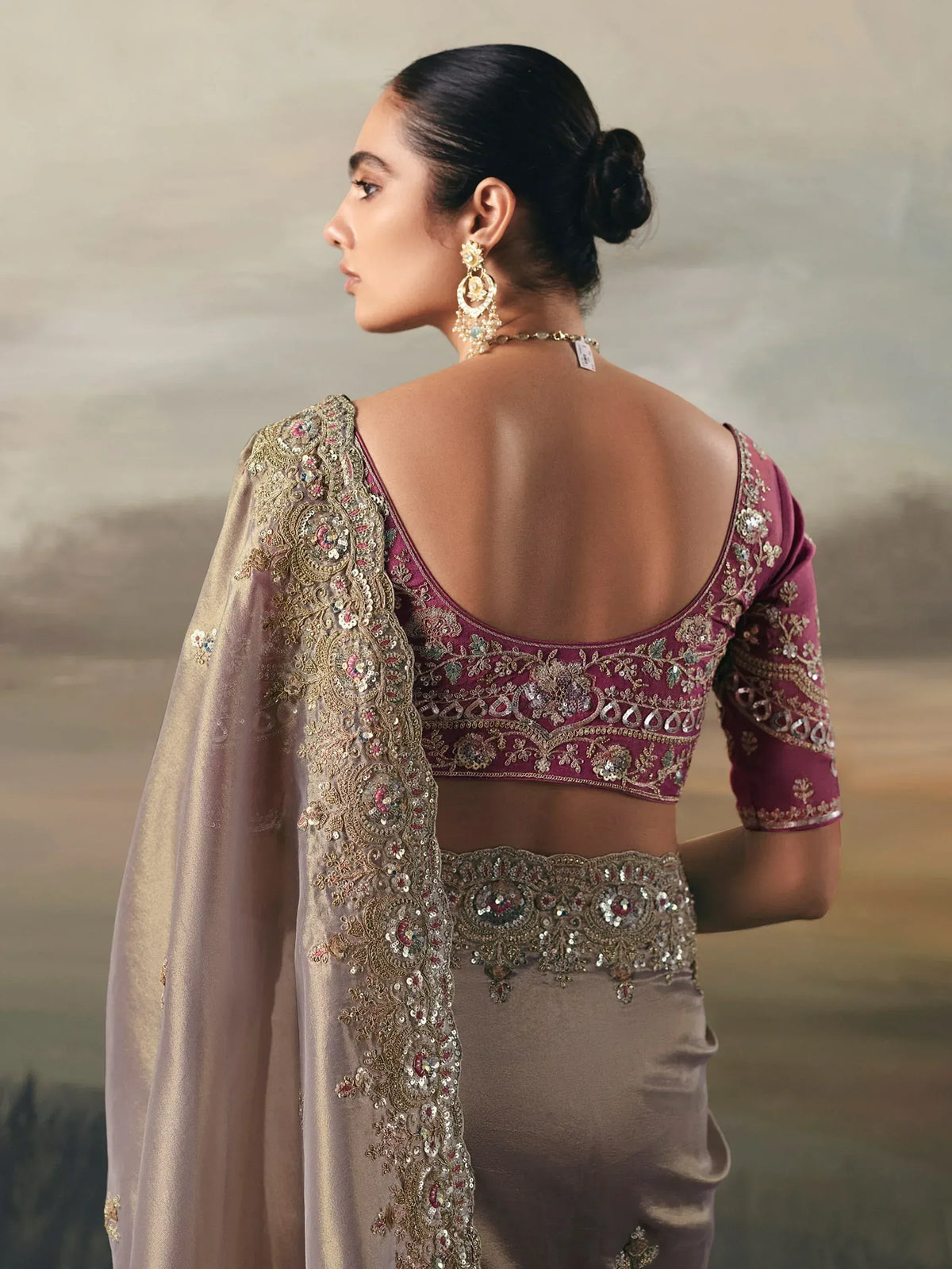 Elegant maroon and gold embroidered lehenga choli with backless blouse and detailed dupatta, perfect for Indian ethnic occasions.