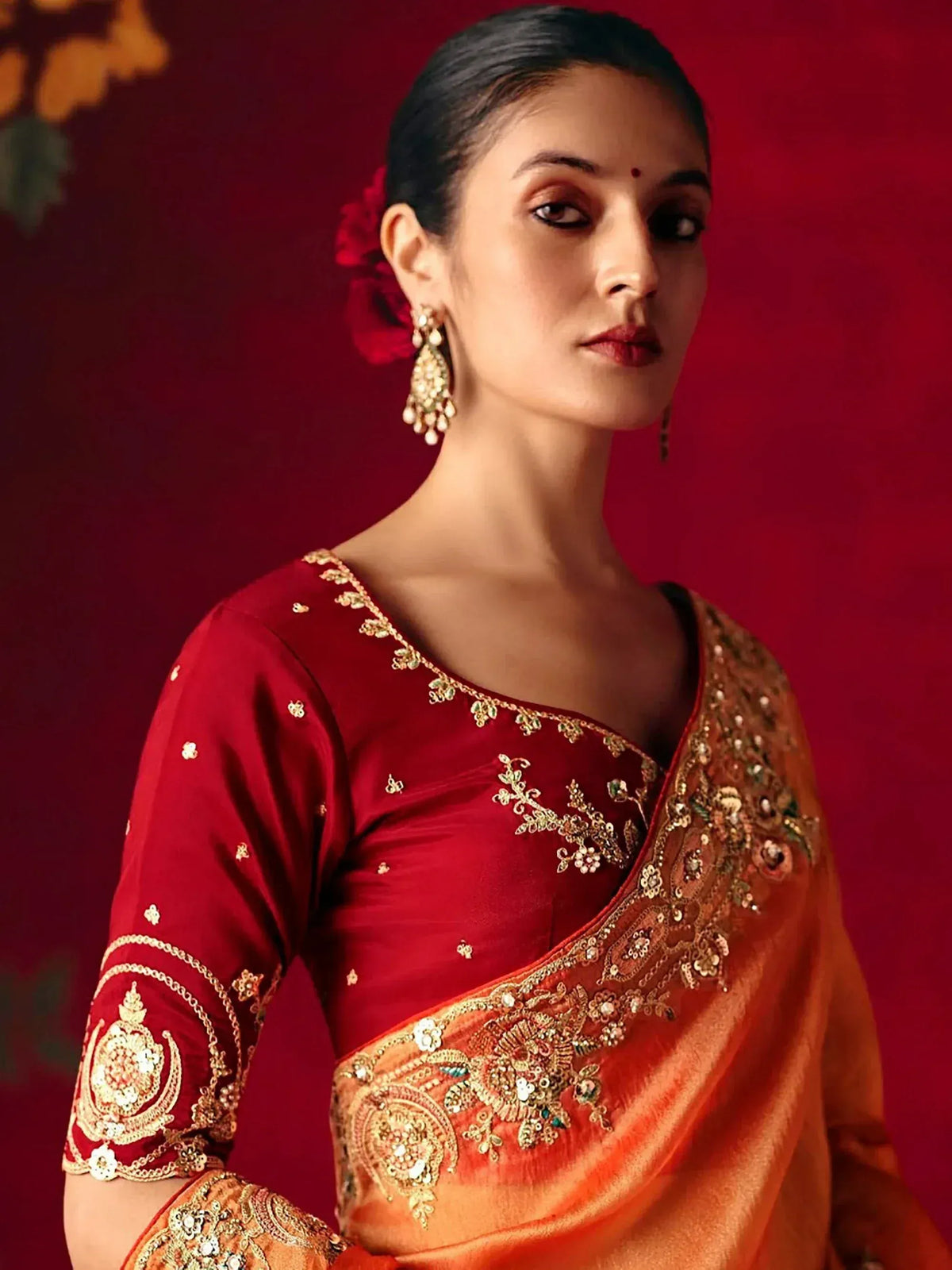 Elegant red and gold embroidered saree with matching blouse, perfect for Indian ethnic occasions.