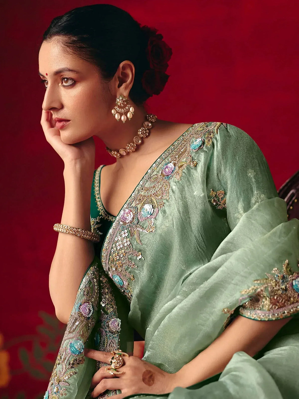 Elegant green embroidered saree with floral motifs, perfect for Indian ethnic wear occasions.