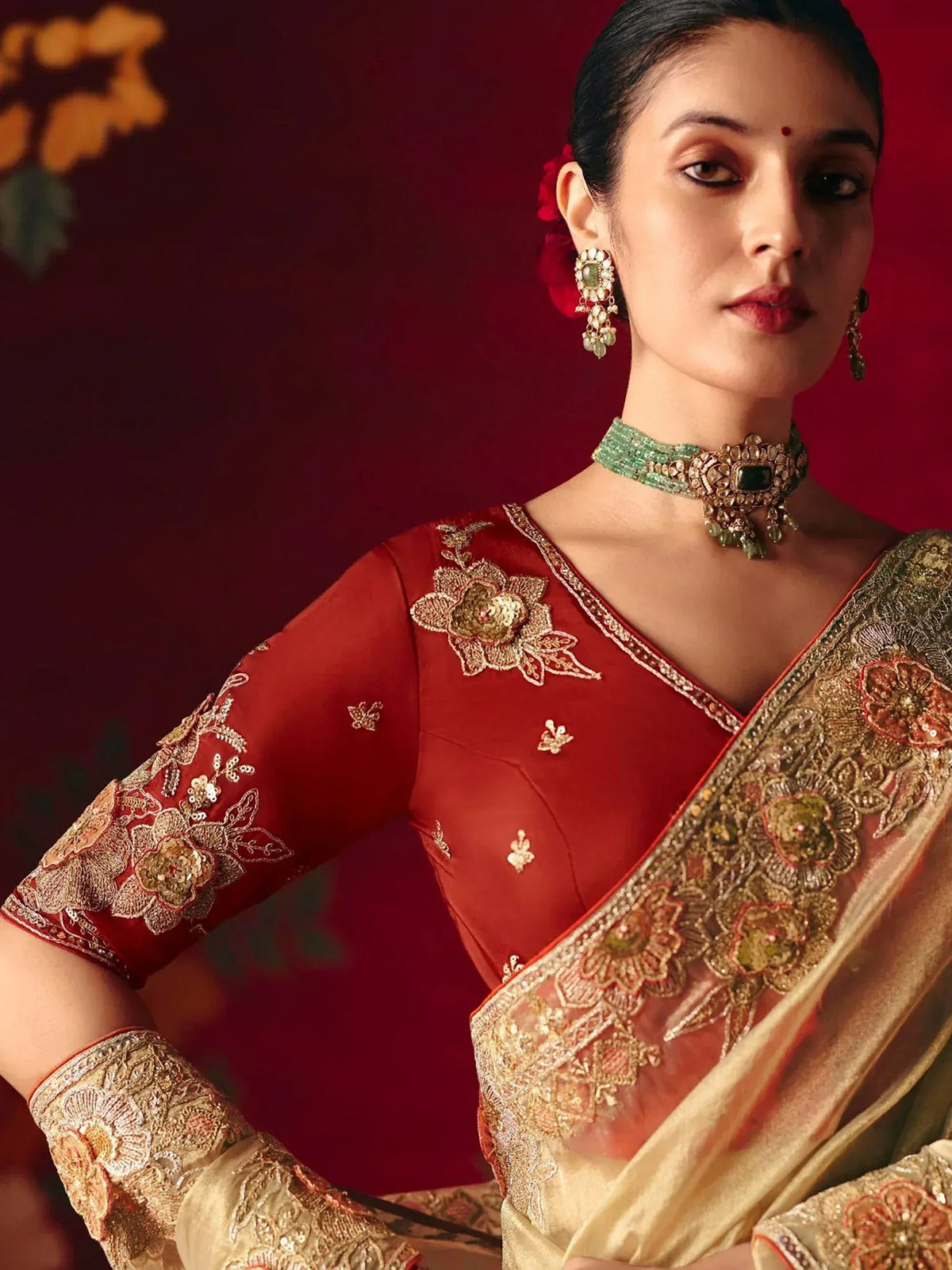 Red and gold embroidered saree with floral detailing, perfect for Indian ethnic wear occasions.