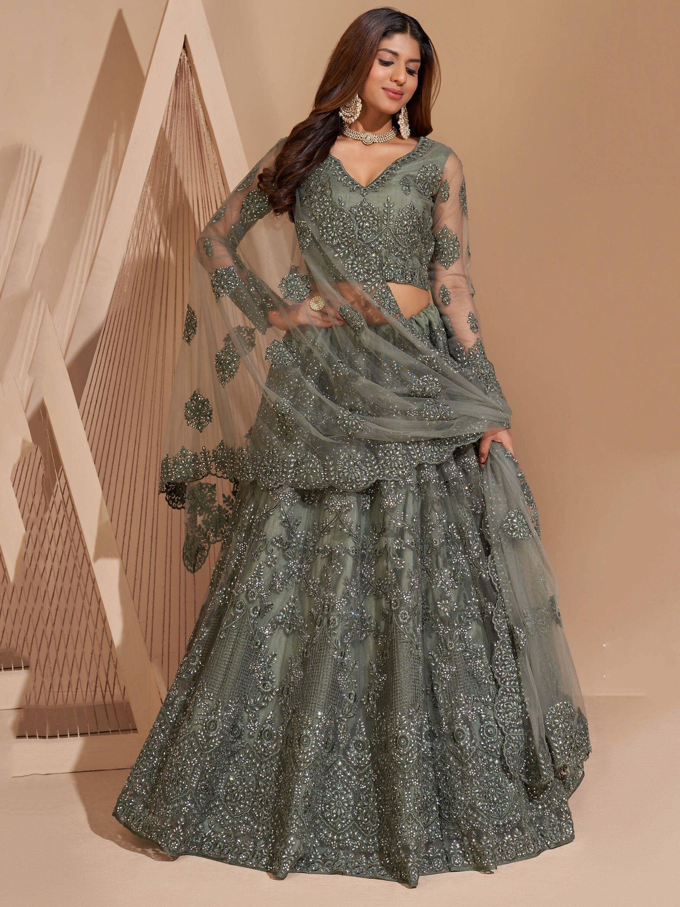 Olive green designer lehenga choli with heavy embroidery and sheer dupatta, perfect for weddings and festive occasions.