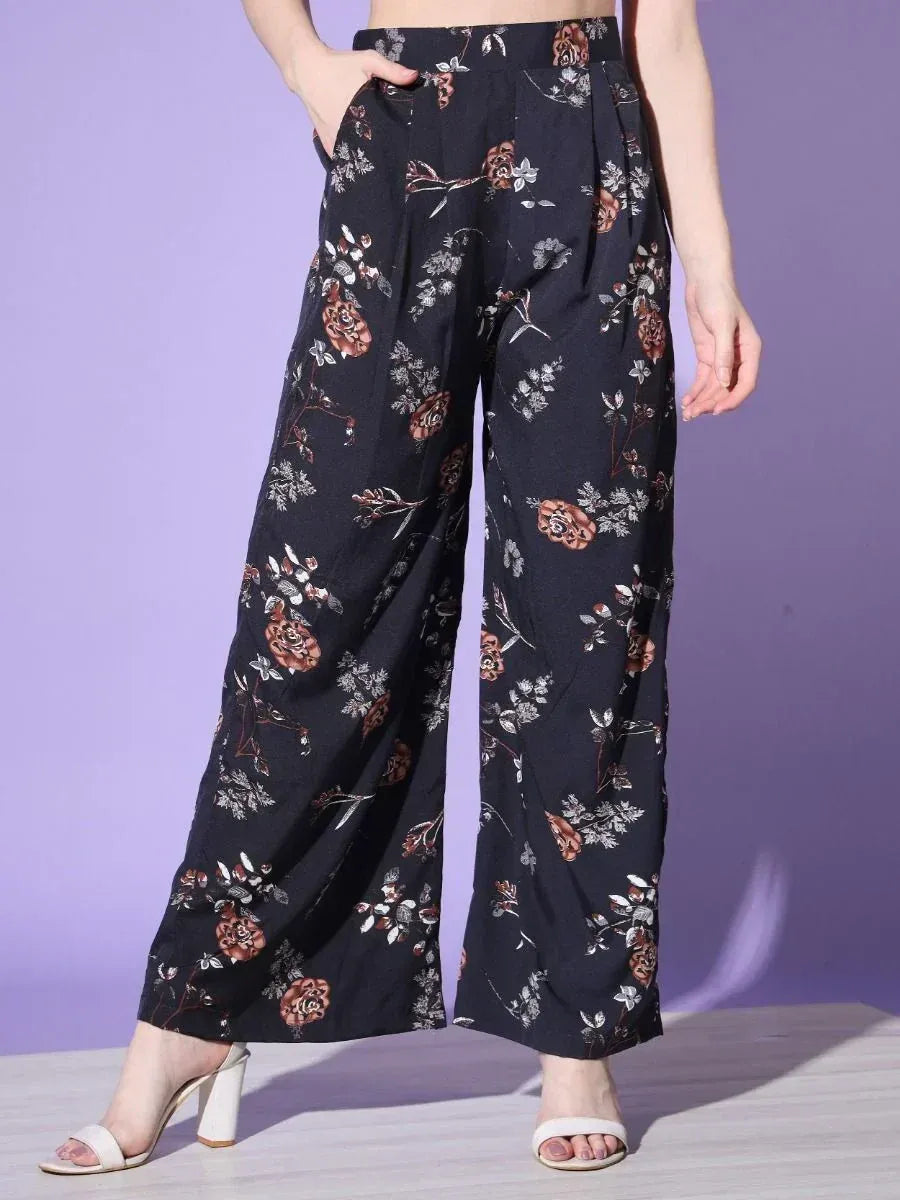 Black floral print palazzo pants with high waist, paired with white heels, ideal for ethnic wear