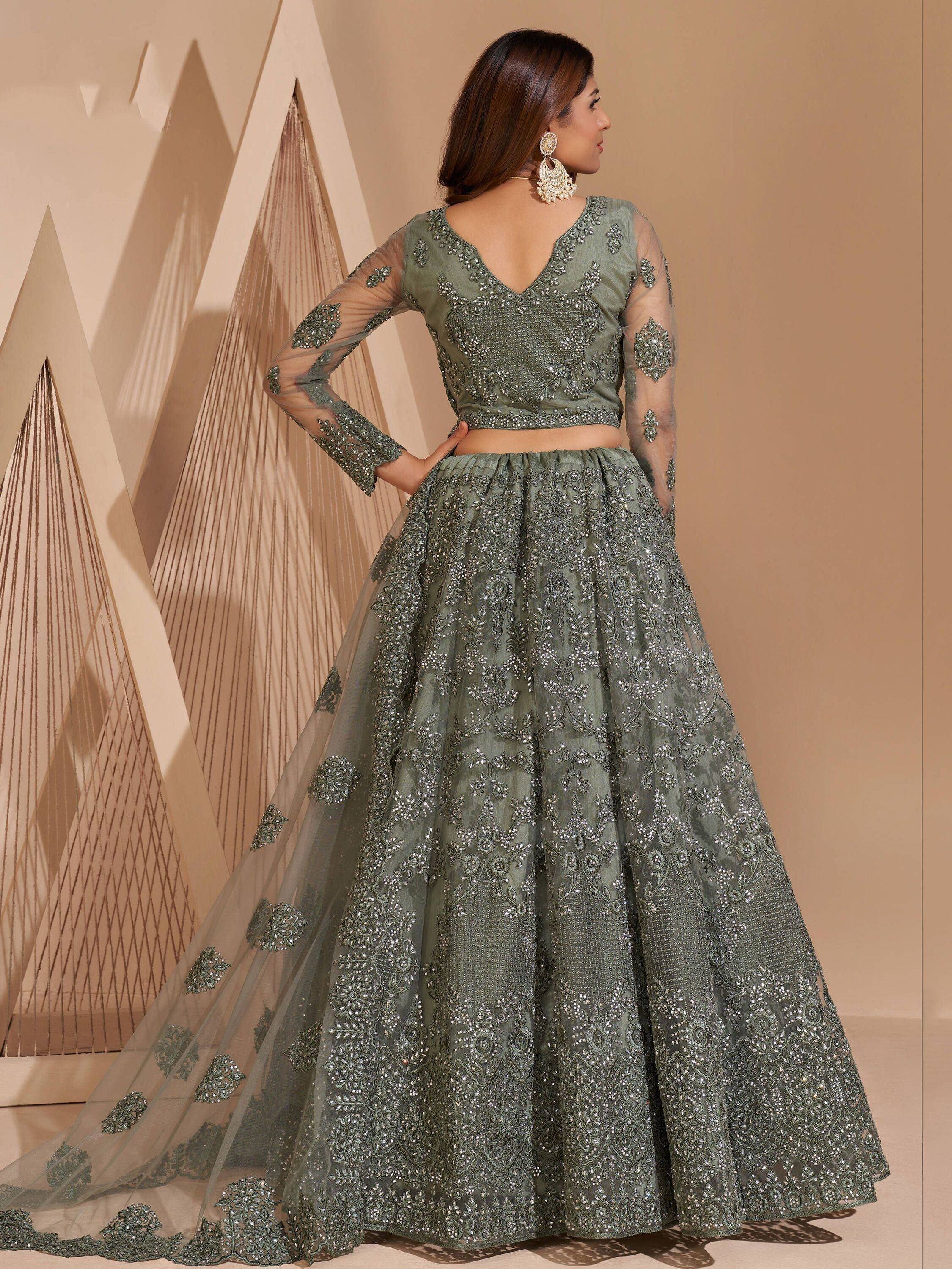 Olive green designer lehenga choli with heavy embroidery and sheer sleeves, perfect for Indian weddings.