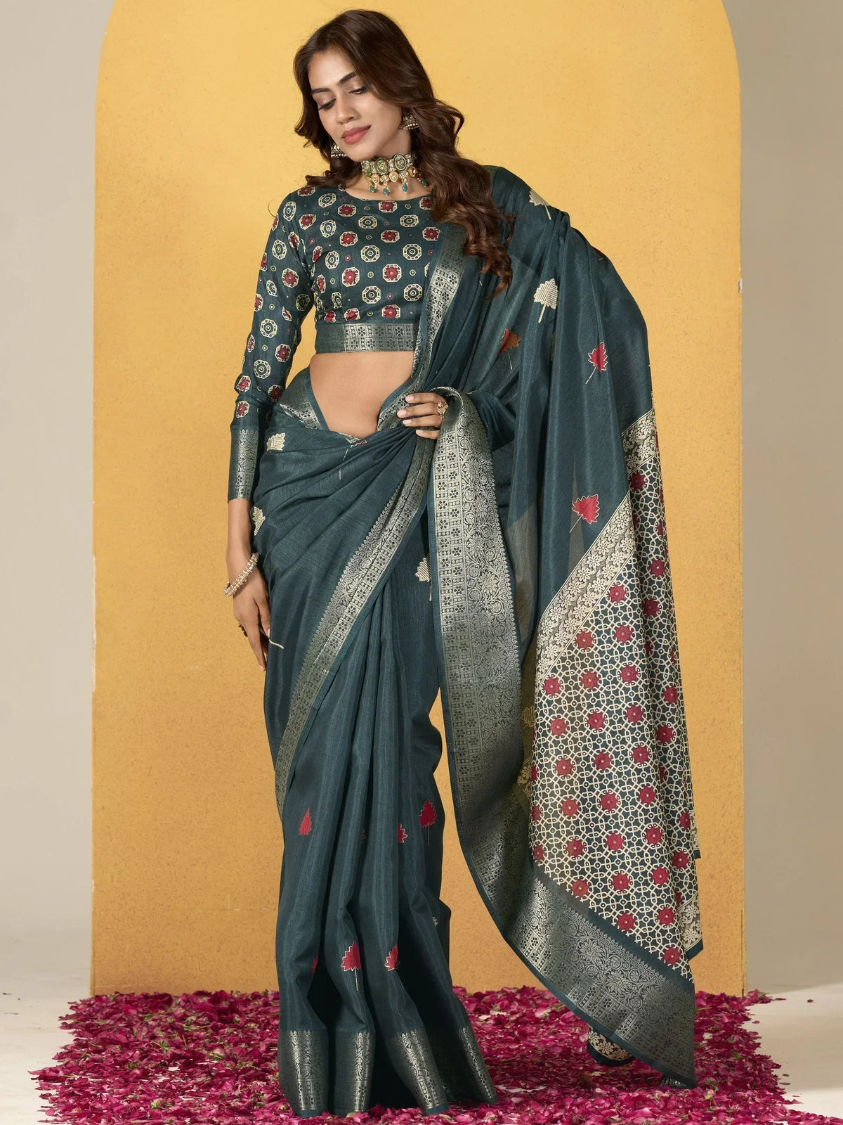 Teal designer saree with red floral print and silver border, paired with matching blouse, ideal for ethnic occasions.