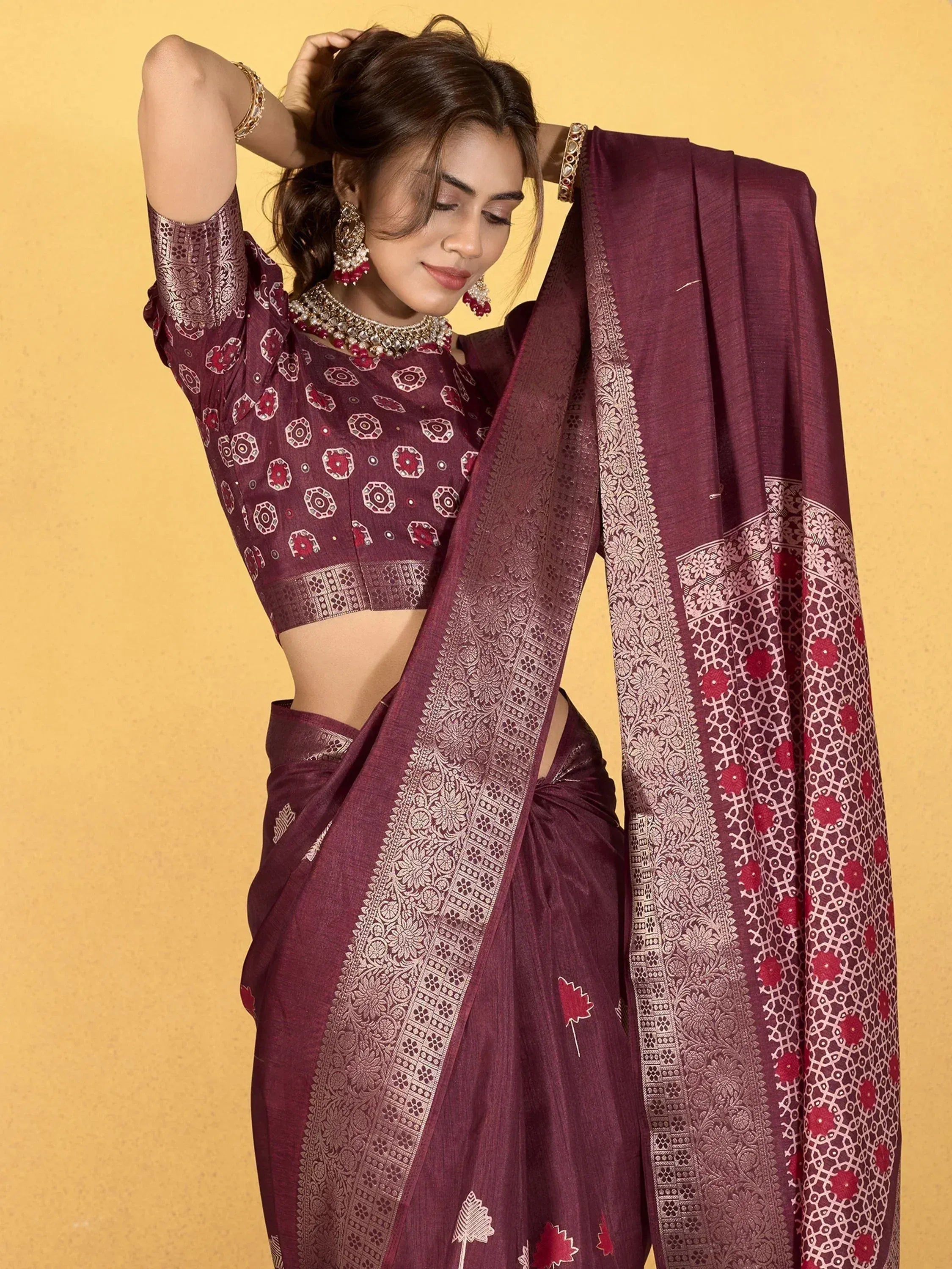 Elegant maroon saree with intricate gold and red embroidery, paired with matching blouse for Indian ethnic wear