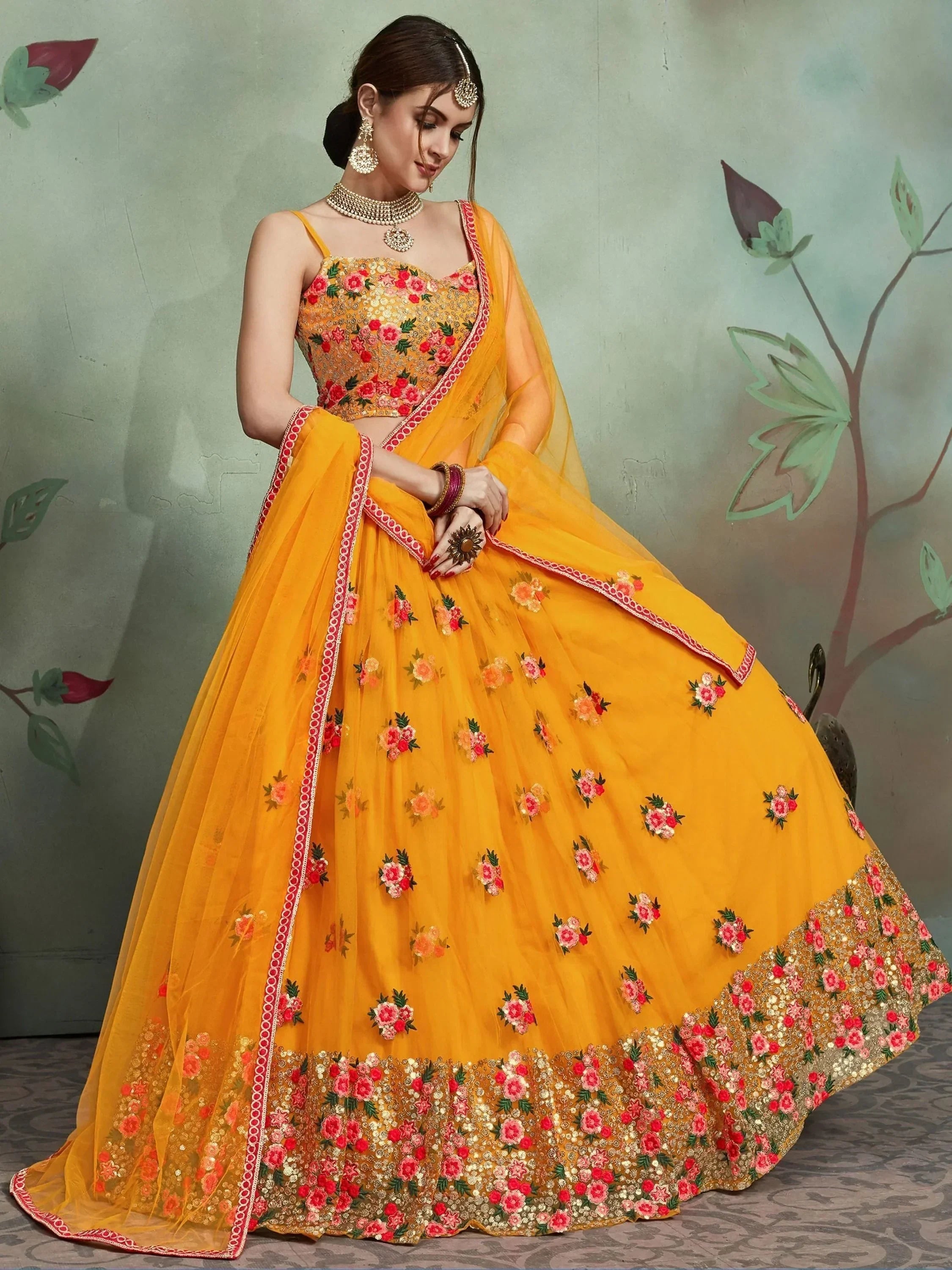 Yellow floral embroidered lehenga choli with gold detailing, perfect for Indian weddings and festive occasions