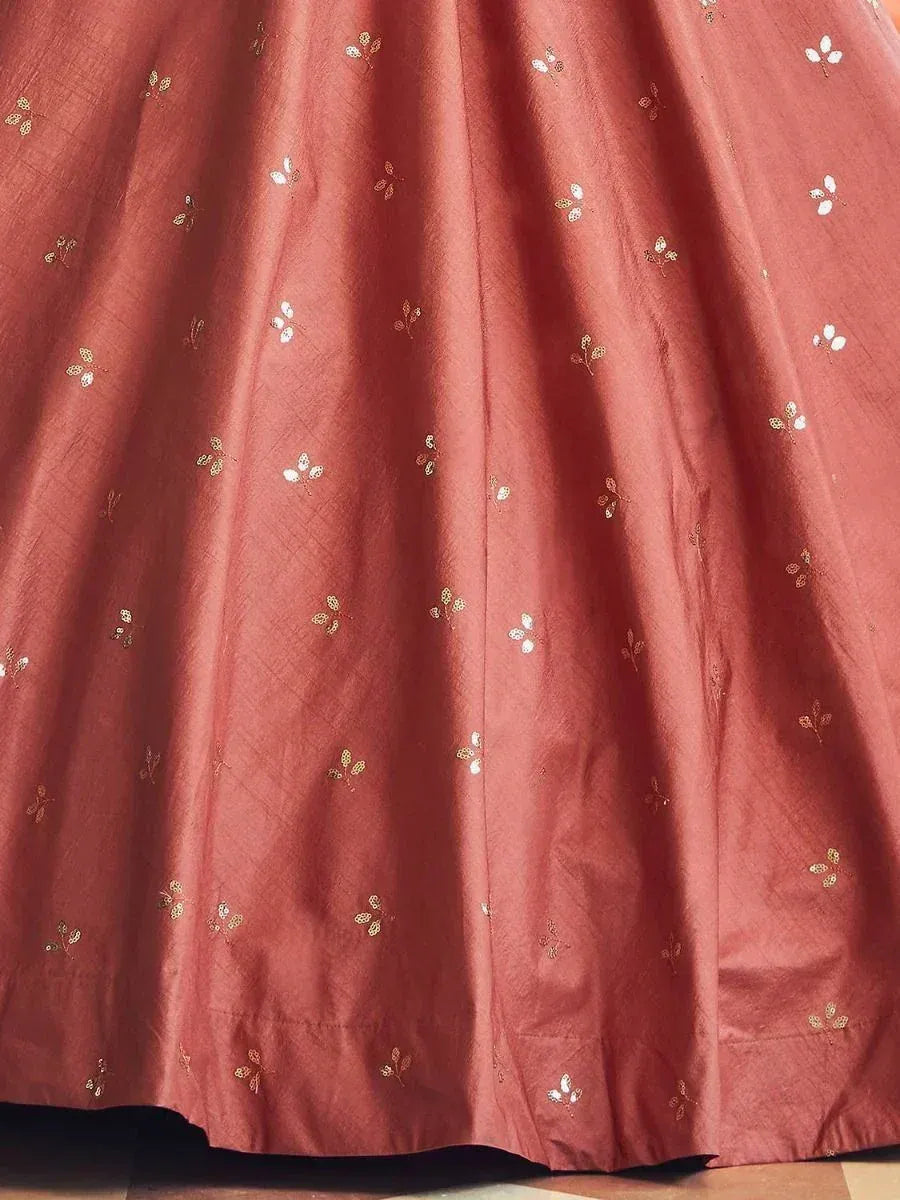 Rust-colored lehenga with gold and white floral embroidery, ethnic Indian wear