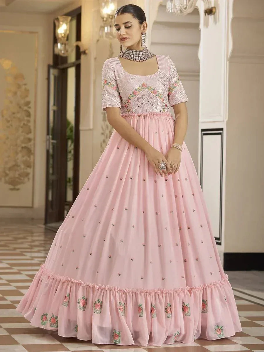 Pink embroidered ethnic gown with floral detailing, perfect for Indian weddings and festive occasions.