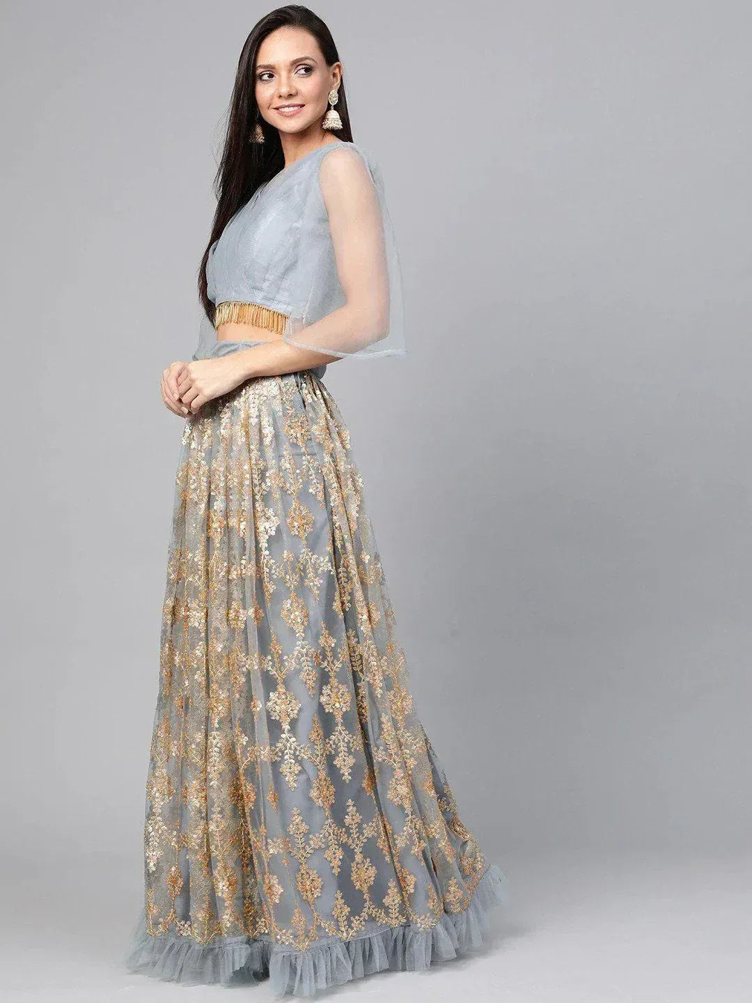 Grey lehenga choli with gold embroidery, sheer cape, and tassel waistband for Indian ethnic wear
