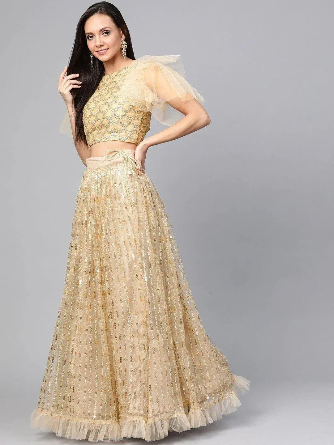 Gold sequin lehenga choli with sheer puff sleeves, perfect for Indian ethnic wear events