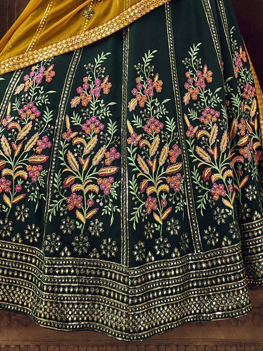 Black lehenga with vibrant floral embroidery and gold detailing, paired with mustard dupatta
